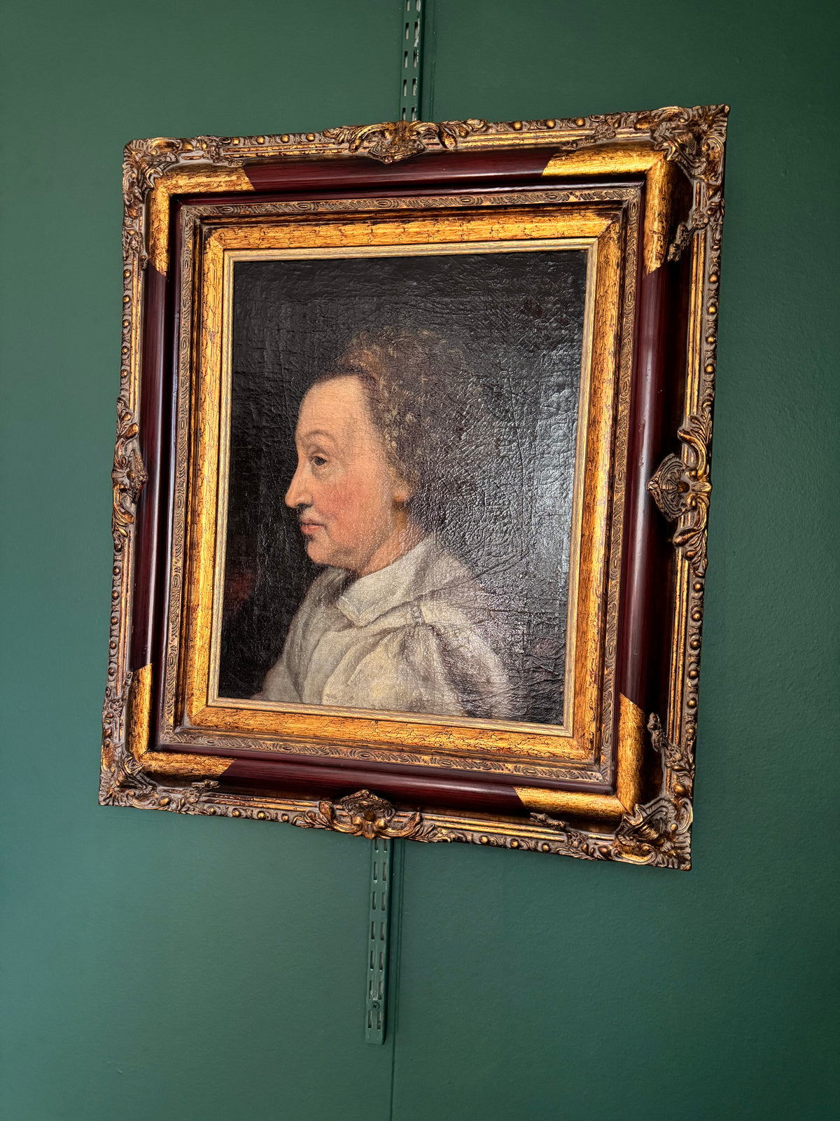 Angled view of the framed antique profile portrait