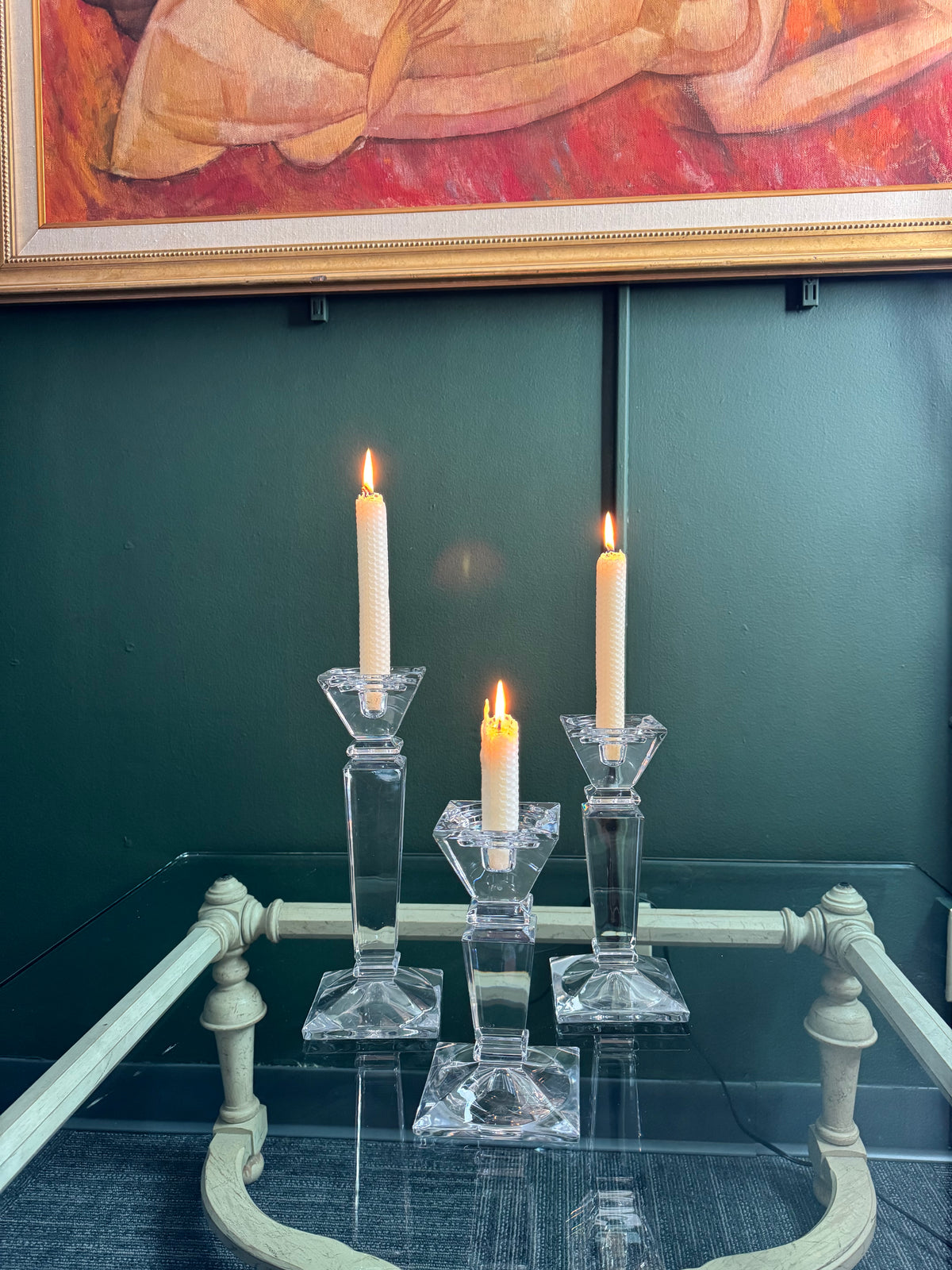 Set of 3 crystal candle holders displayed on a glass console table